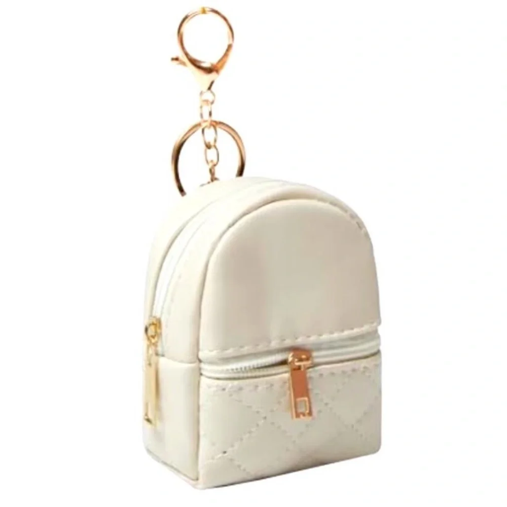 Mini backpack keychain charms, blue, pink, black, cream colors.